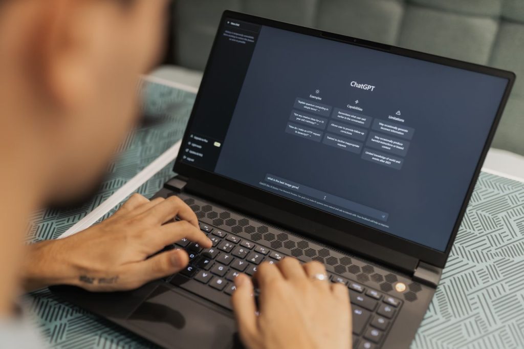 pexels photo 16094040 Close-up of a person typing on a laptop displaying the ChatGPT interface, emphasizing modern technology use.
