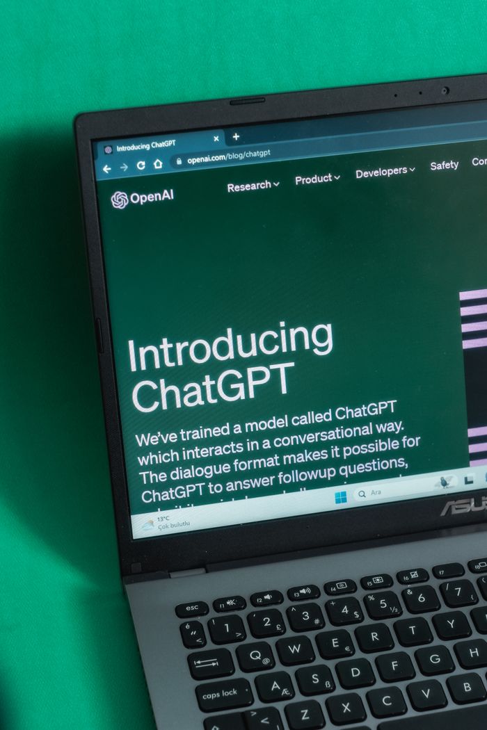Laptop screen displaying the introductory page of ChatGPT on OpenAI's website.