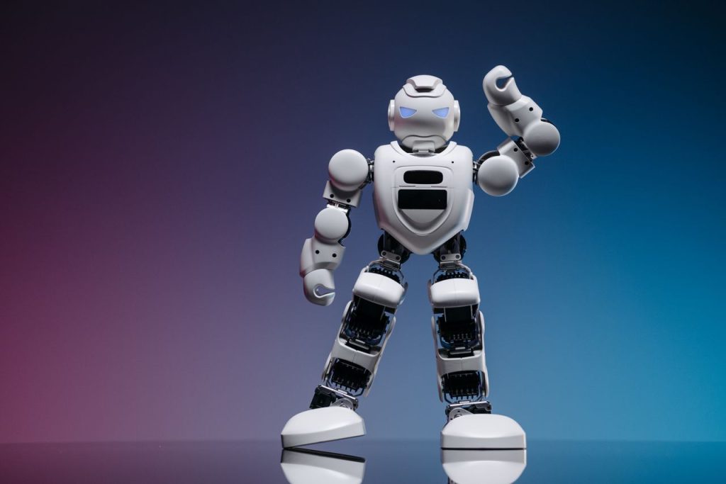 A sleek white robot in a studio setting against a gradient background, showcasing modern robotics.